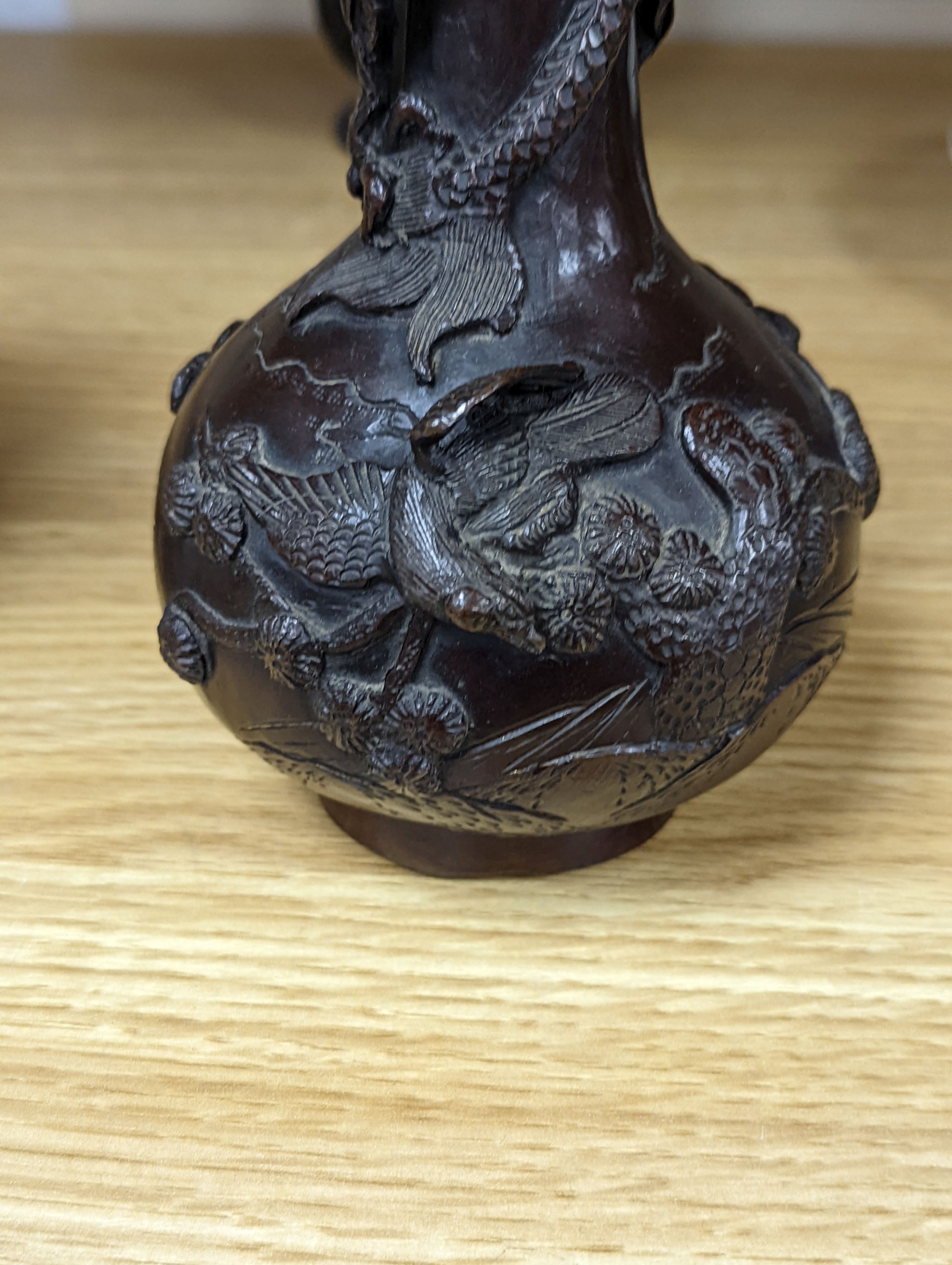 A pair of Japanese Meiji period bronze ‘dragon’ bottle vases and another, 21cm